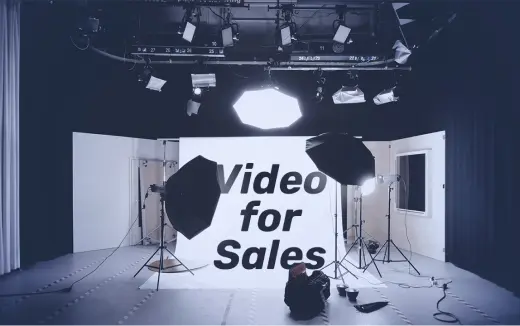 A professional studio setup with lighting and camera equipment for creating sales videos.